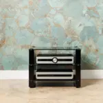 Stax 2G rack in Black Glass / High Gloss Black holding electronics against a tiled wall
