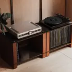 Two LP Collections in black ash plywood with natural walnut supports, holding records beneath a turntable