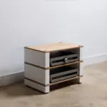 The Blok Stax 2G in natural ash plywood with satin white supports, holding electronics in a living room