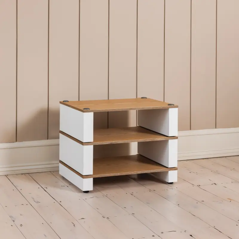 The Blok Stax 2G Base in natural ash plywood with satin white supports, carrying two shelves in a panelled room