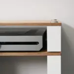 Satin white support between natural ash shelves, with a component in place